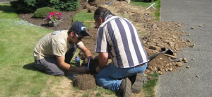 two of our Brantford sprinkler repair pros are fixing a broken system