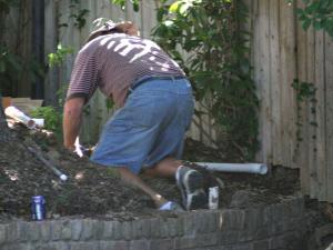 Tim is arranging the pvc pipes for a new sprinkler system installation